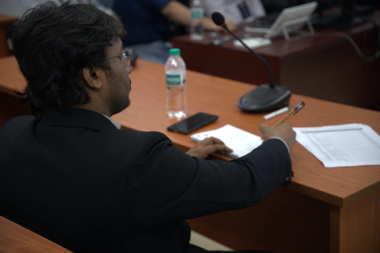 Nafiul Ahmad Rafi reviewing student team presentations at the IUT Datathon